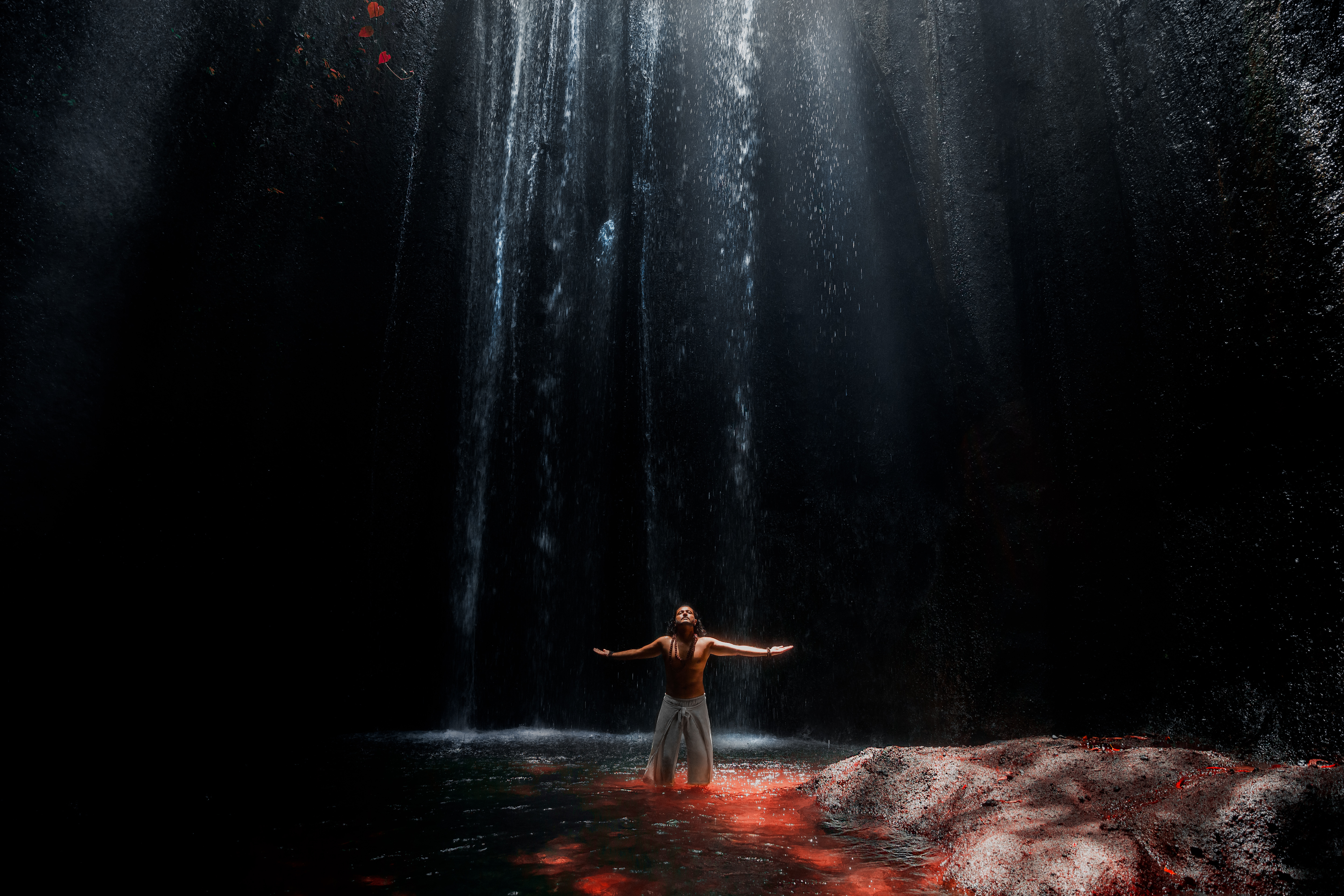 Art piece of Yogi Rohan standing under a waterfall