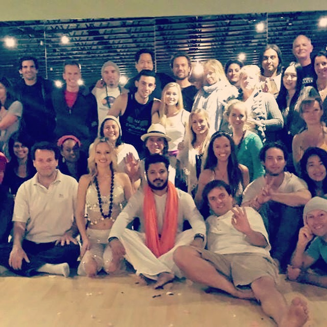 Yogi Rohan seated with a large community group during a class