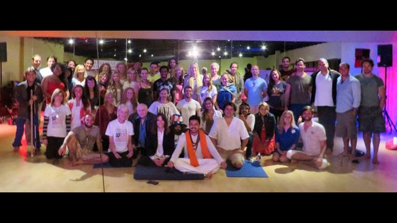 Yogi Rohan teaching a large workshop group indoors