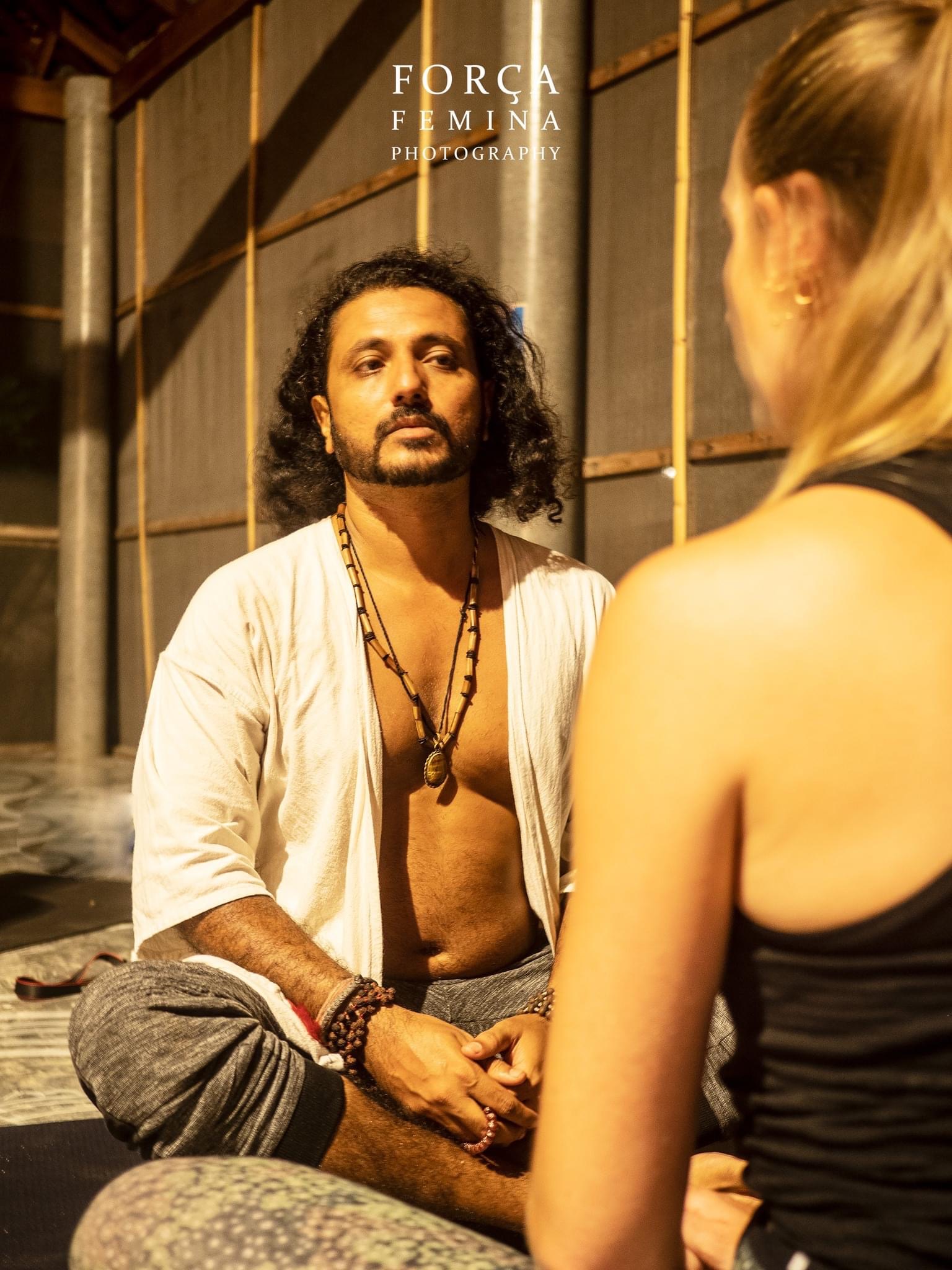 Yogi Rohan guiding a relationship-focused workshop by the pool